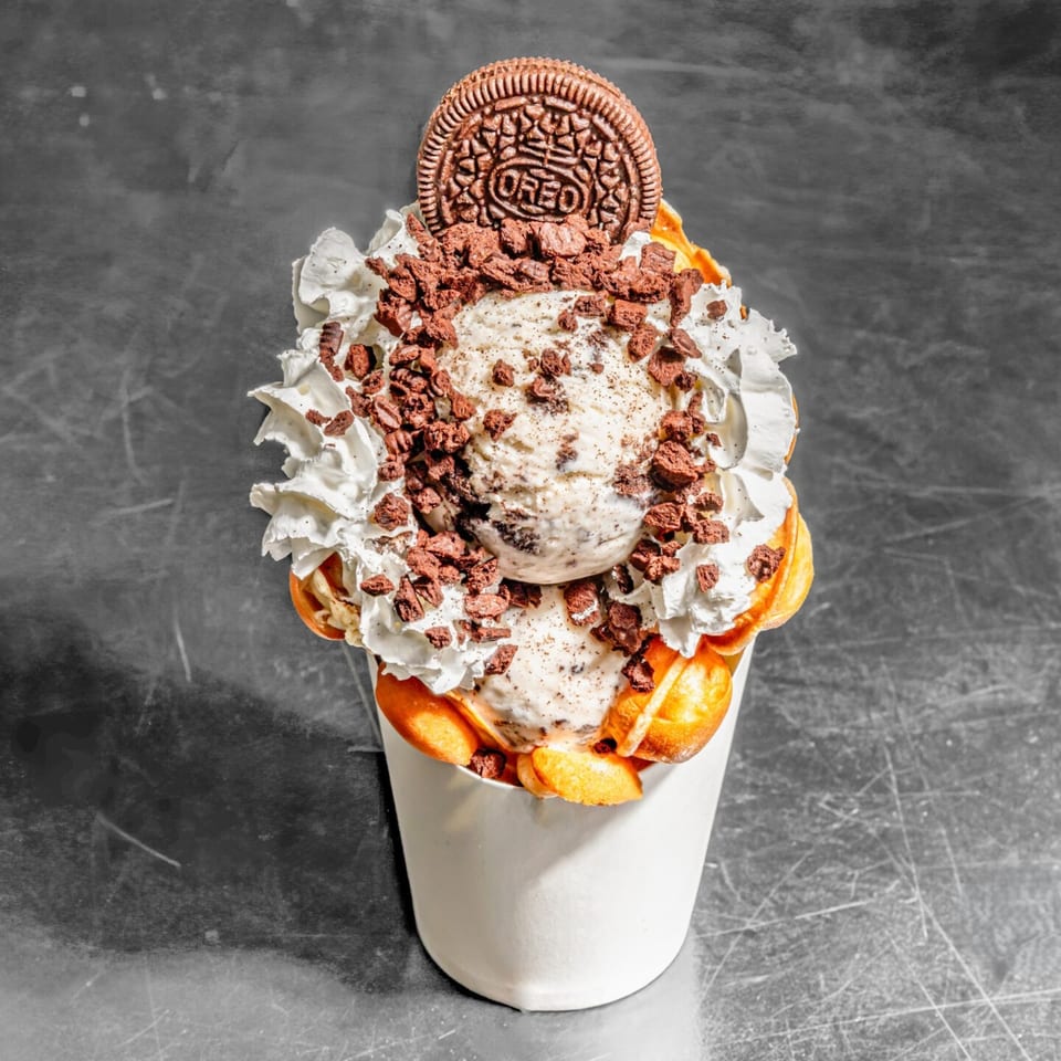 Chunky Bites' bubble waffle dessert with ice cream, whipped cream, cookie crumbles, and an Oreo.